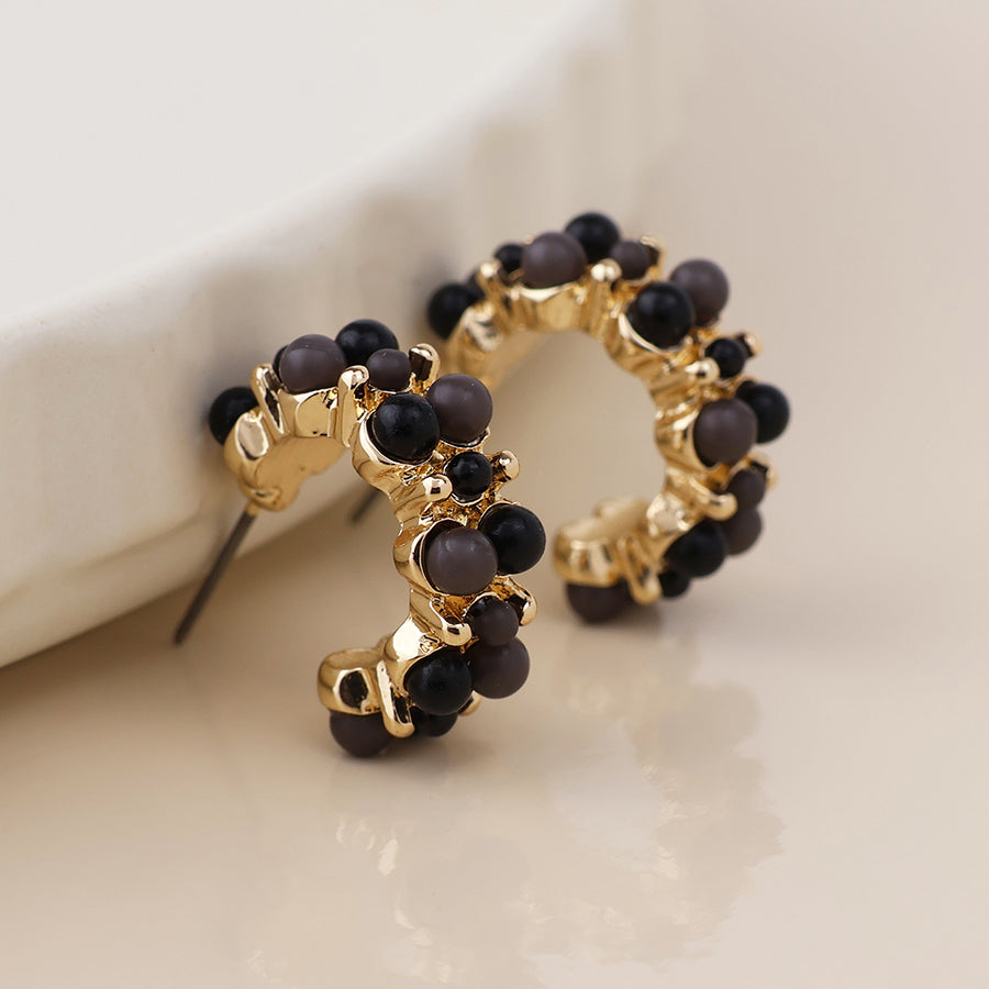 Clara golden cluster hoop earrings in black and gold