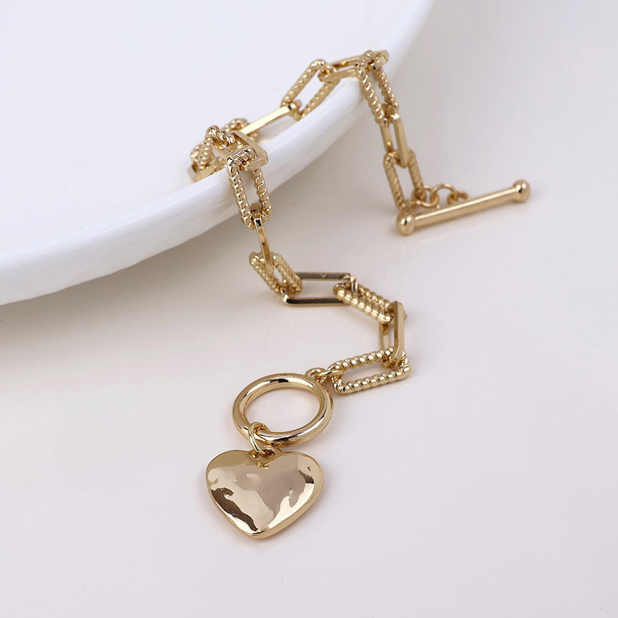 Foundry golden heart and t-bar bracelet with twist links