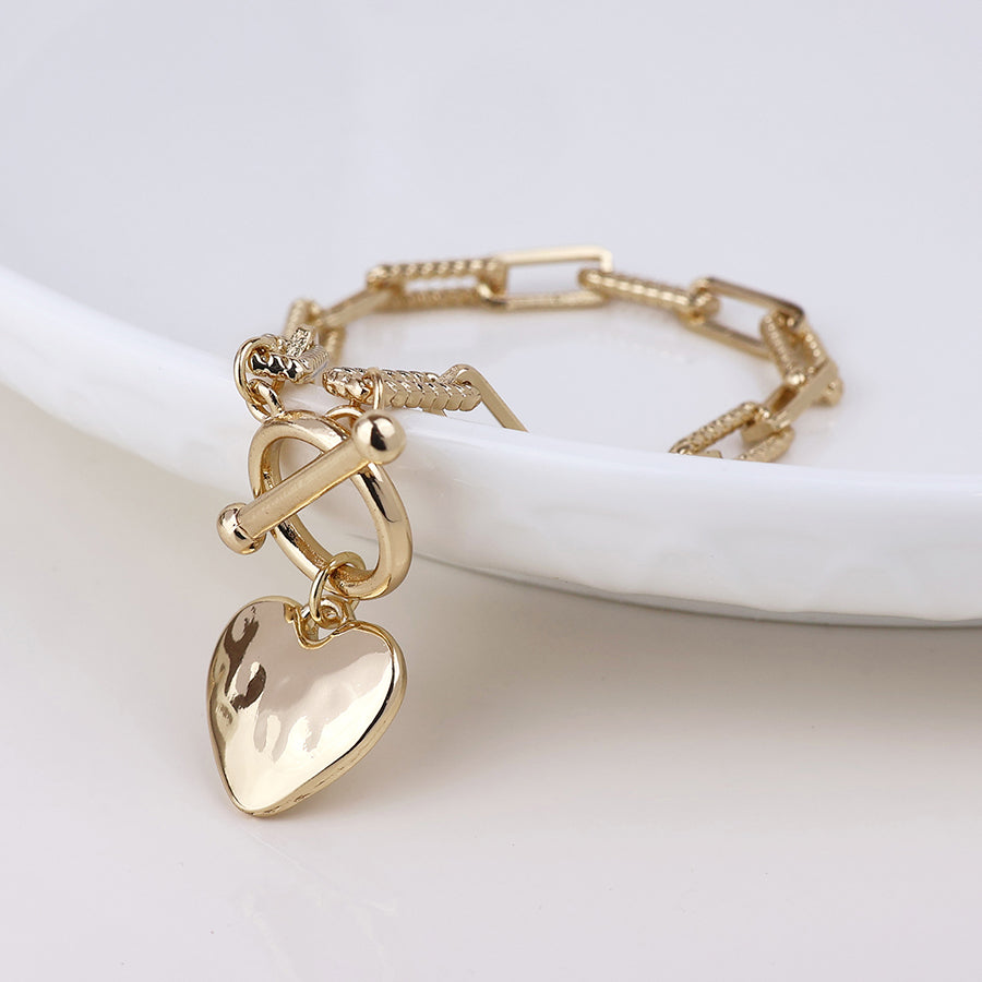 Foundry golden heart and t-bar bracelet with twist links