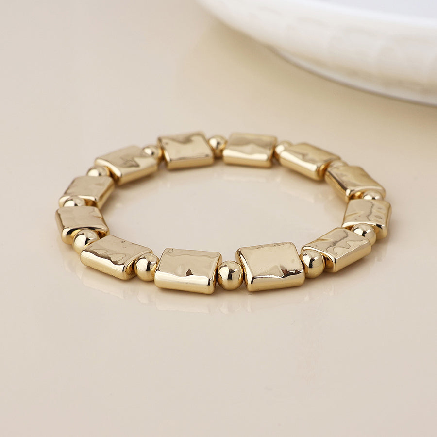 Cassia golden polished bead and oblong stretch bracelet